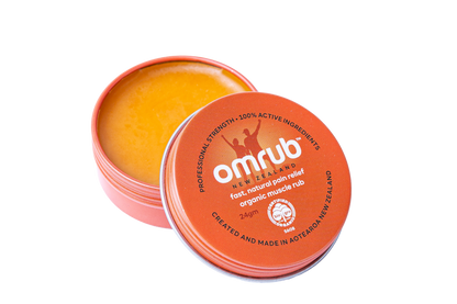 Open container of Omrub Organic Muscle Rub, an orange balm with &
